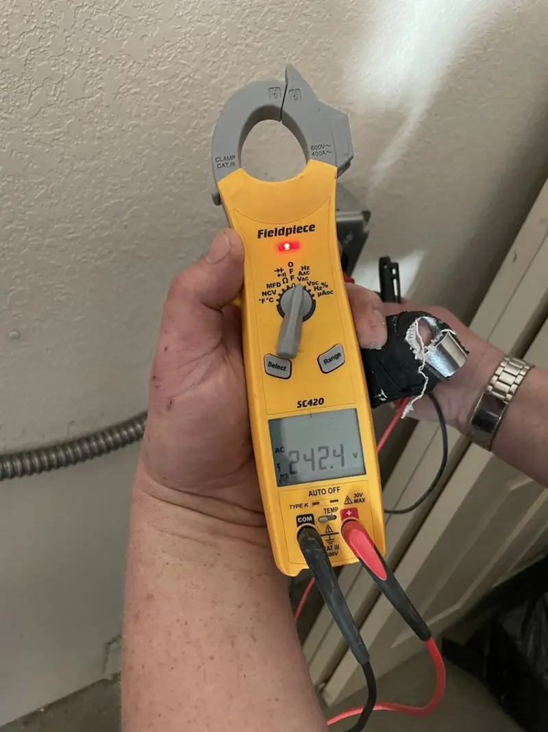 Voltage testing with clamp meter during Aluminum Wiring Replacement in Miami Heights